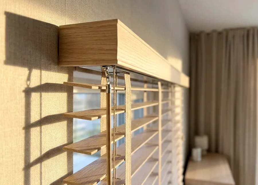 Close-up of a blind headrail and its lift mechanism during a service visit